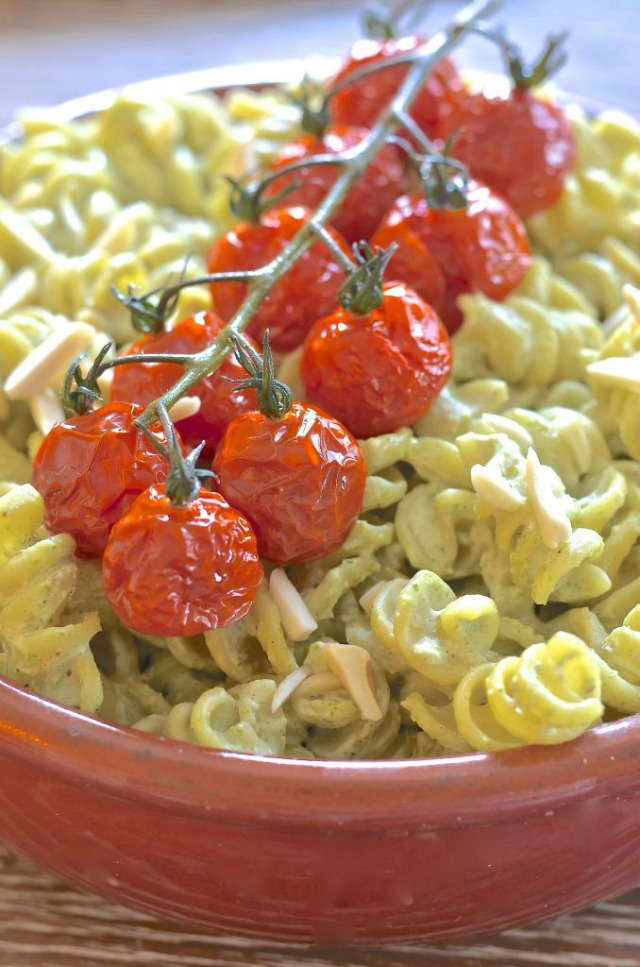 Creamy Vegan Pasta Salad topped with a stem of roasted tomatoes.