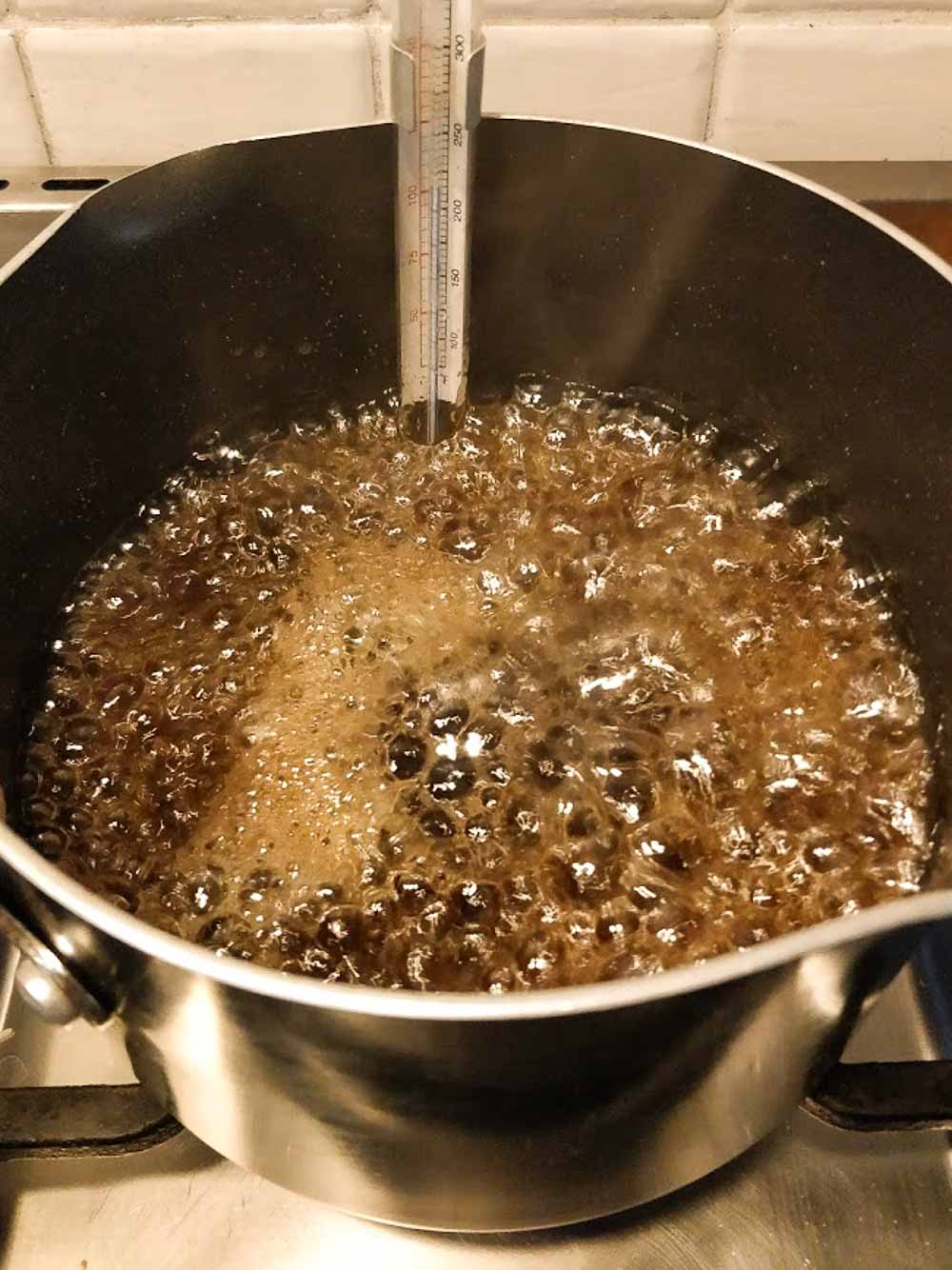 A pan of boiling sugar caramel.