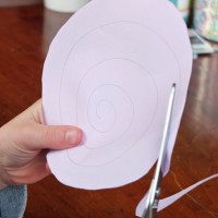 Cutting a paper spiral with scissors