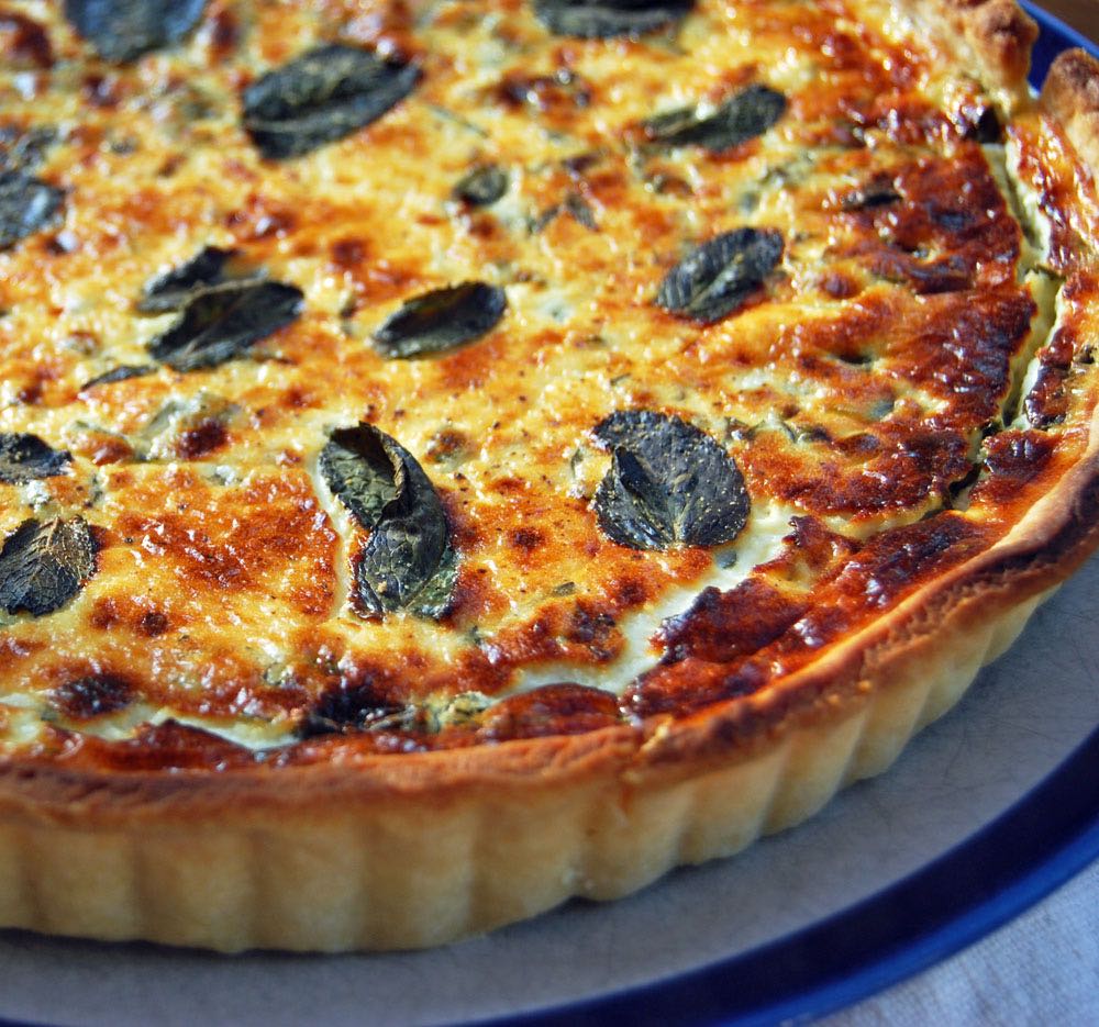 Baked goats' cheese tart with a golden brown top.