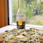 Spring Vegetable Pizza served with beer.