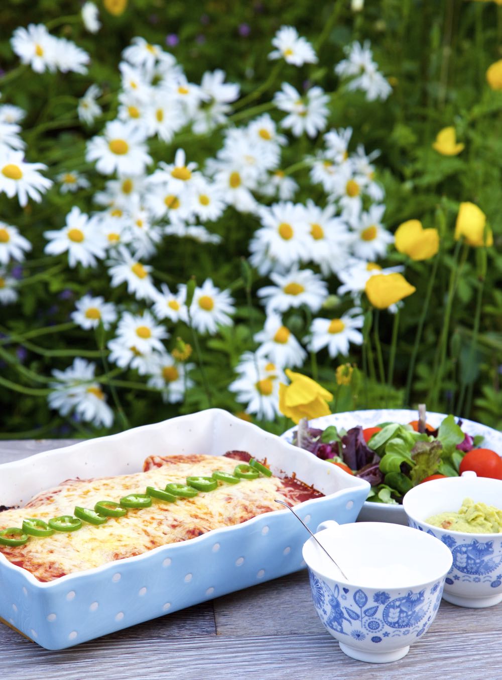 Vegetarian Enchiladas with Quorn Chicken and Refried Beans, alongside guacamole and salad.