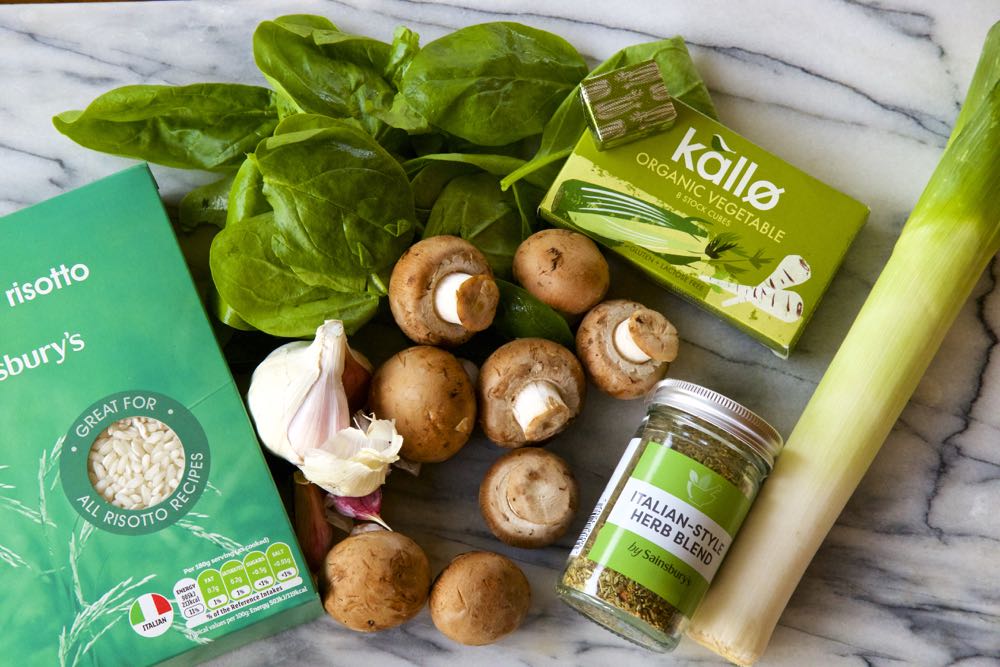 Vegan mushroom risotto ingredients laid out on a chopping board.
