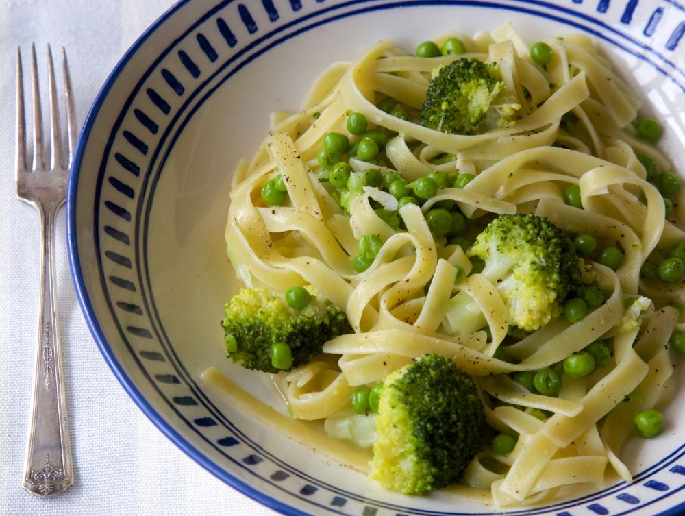 A serving of creamy one pot pasta with broccoli and peas.