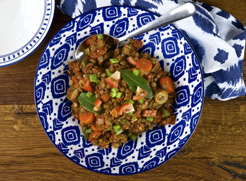 Braised lentils with vegan sausages, tomatoes and peppers.