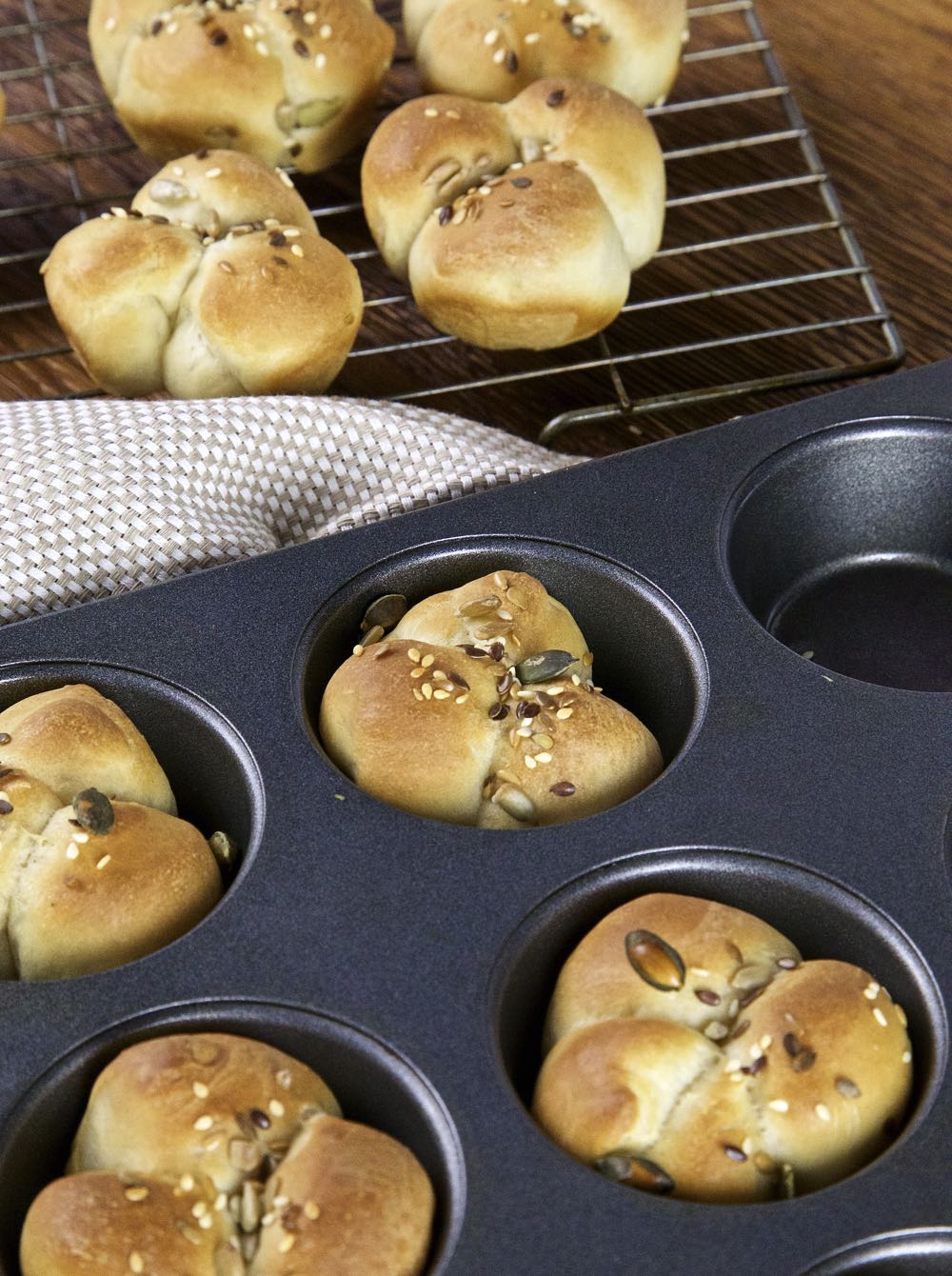 Lucky Cloverleaf rolls cooling in a muffin tin.