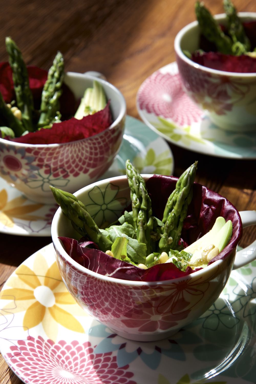 Asparagus Avocado Salad with lemon and caper dressing presented in tea cups.