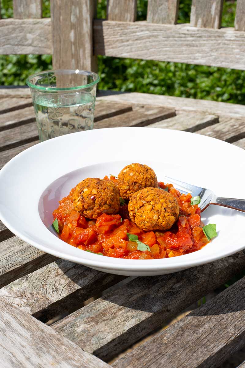 Lentil Meat Balls served with a fresh tomato sauce in the garden.