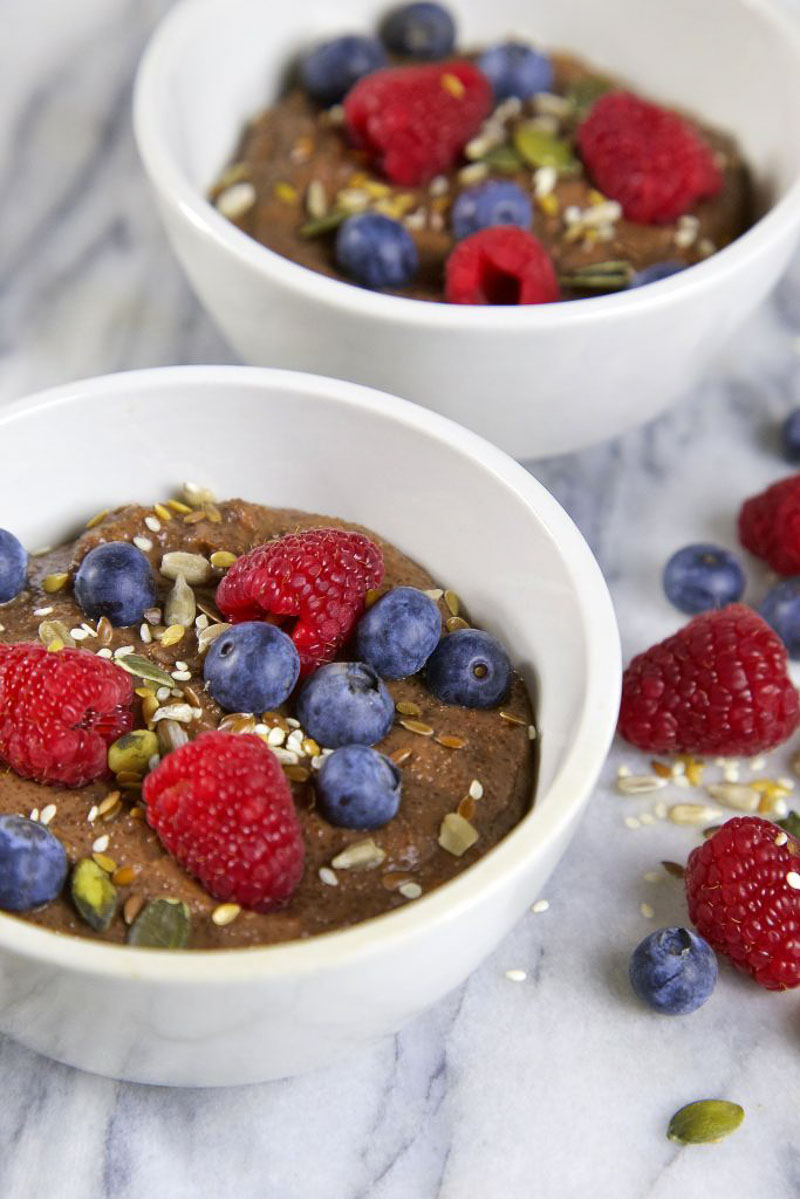 Cooking with Ancient Grains, A Bowl of Chocolate Teff Porridge topped with raspberries and blueberries.