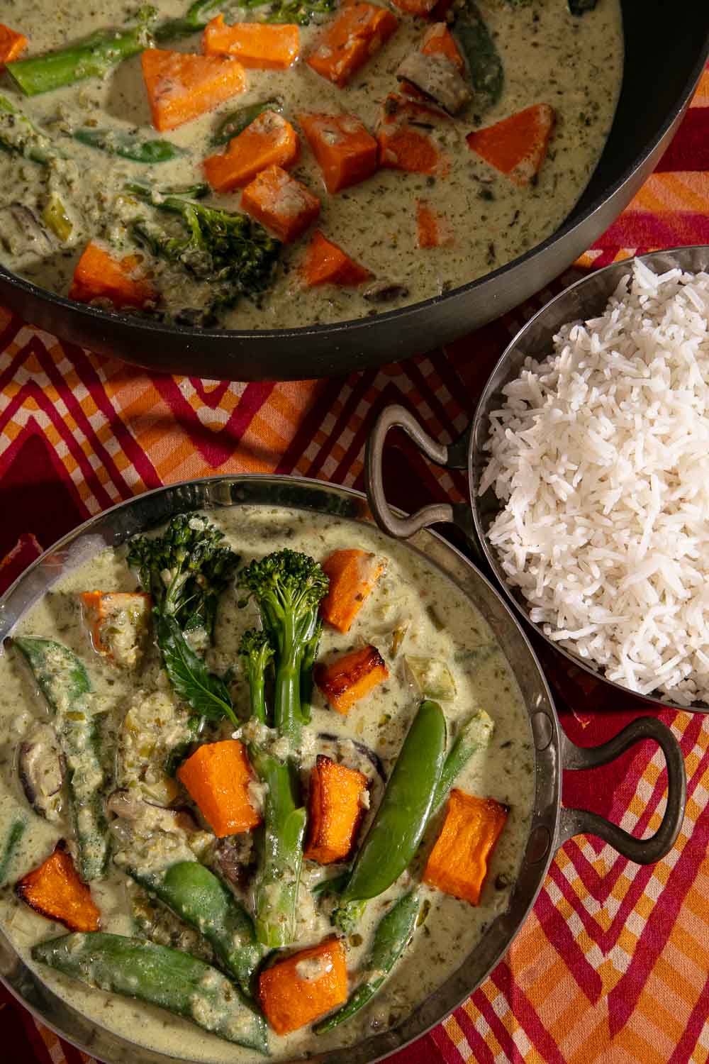 A bowl and pan of vegan Thai Green Curry and a bowl of rice.